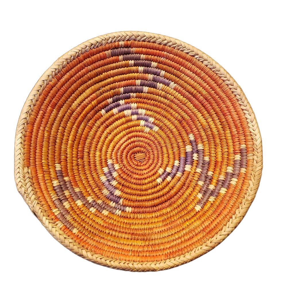 Artisanal Charm: Handwoven Grass Basket with Red and Blue Accents